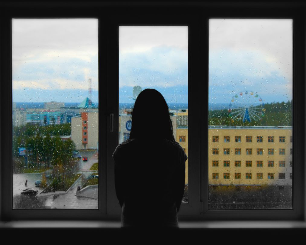 woman looking out the window
